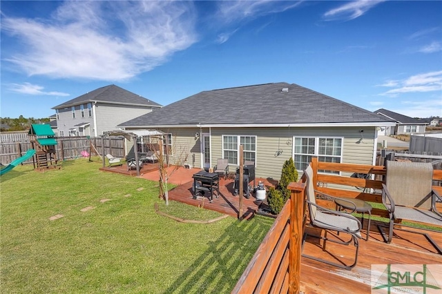 back of house with a yard, a playground, a deck, and a patio area