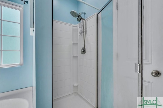 bathroom featuring a wealth of natural light and walk in shower