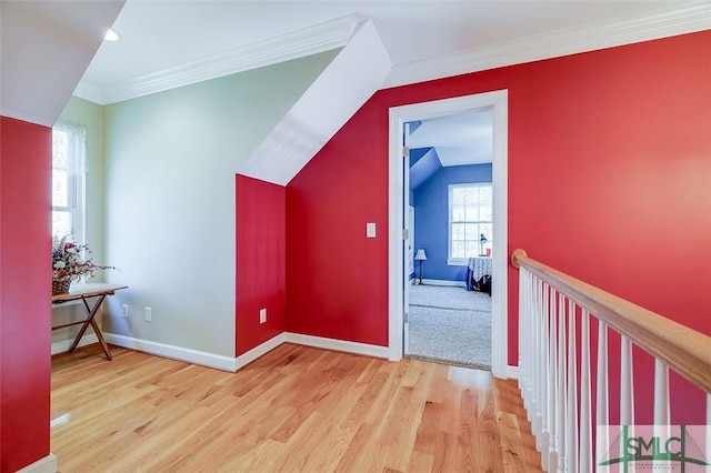 additional living space featuring lofted ceiling and light hardwood / wood-style floors