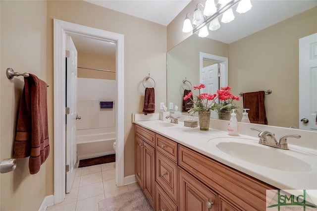 full bathroom with washtub / shower combination, vanity, tile patterned floors, toilet, and a chandelier