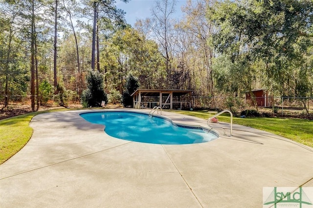 view of swimming pool featuring a patio area and a lawn