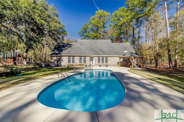 view of pool with a yard and a gazebo