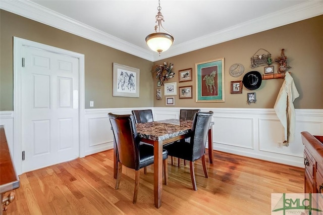 dining area with crown molding and light wood-type flooring