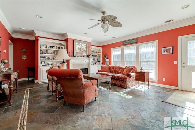 living room with built in shelves, ceiling fan, and ornamental molding