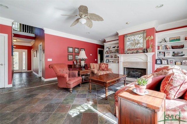 living room with built in shelves, ornamental molding, and ceiling fan