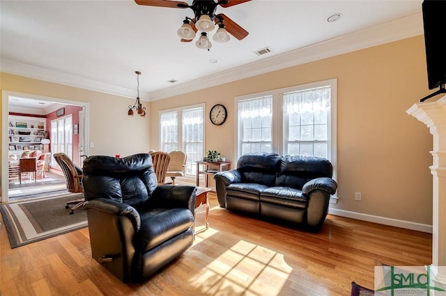 living room with crown molding, ceiling fan, and light hardwood / wood-style floors