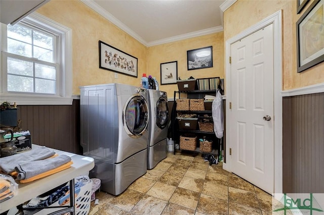 laundry area featuring independent washer and dryer, ornamental molding, and wooden walls