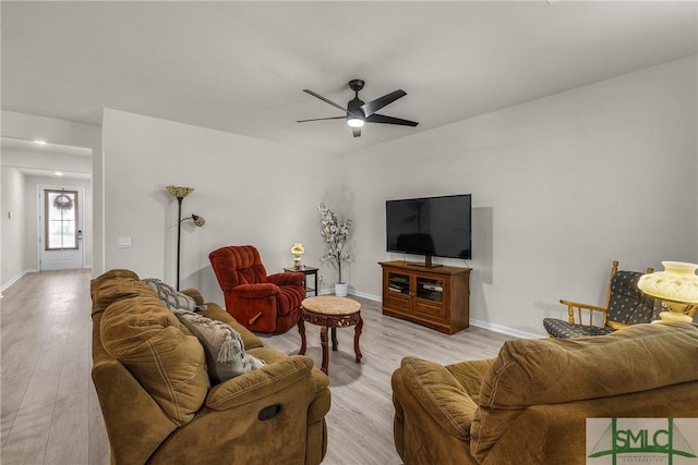 living room with ceiling fan and light hardwood / wood-style flooring