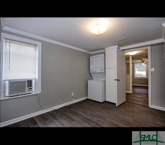 clothes washing area with crown molding, dark wood-type flooring, cooling unit, cabinets, and stacked washer / dryer