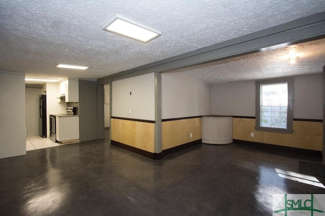 unfurnished room with concrete floors and a textured ceiling