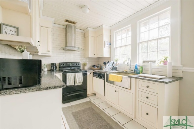 kitchen featuring light tile patterned flooring, electric range, white dishwasher, wall chimney range hood, and backsplash