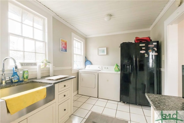 laundry area with washing machine and clothes dryer, ornamental molding, sink, and light tile patterned floors