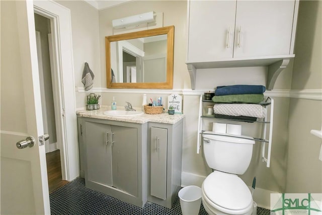 bathroom with vanity, tile patterned floors, and toilet