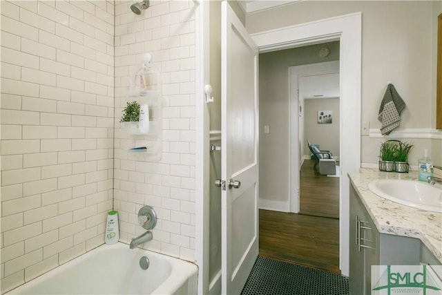 bathroom with vanity and tiled shower / bath combo