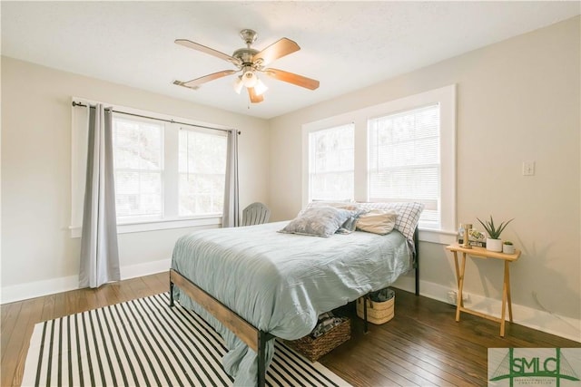 bedroom featuring dark hardwood / wood-style flooring and ceiling fan