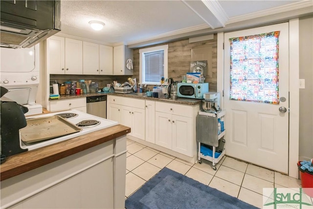 kitchen with light tile patterned floors, a textured ceiling, white cabinets, wood counters, and stainless steel dishwasher