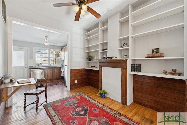 interior space featuring sink, ceiling fan, and light wood-type flooring