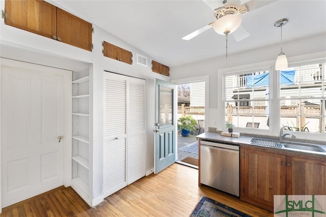 kitchen featuring pendant lighting, sink, stainless steel dishwasher, ceiling fan, and light hardwood / wood-style flooring