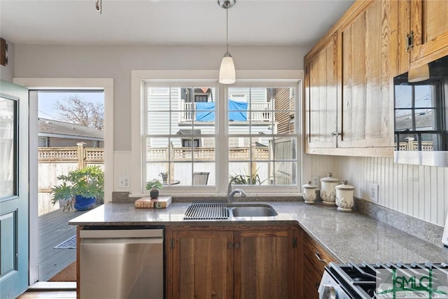 kitchen featuring dishwasher, sink, and decorative light fixtures