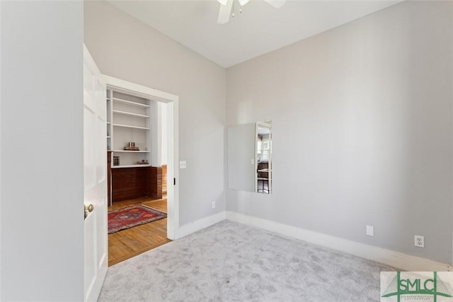 carpeted empty room featuring ceiling fan