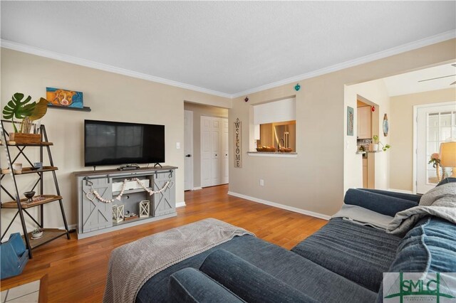 living room with hardwood / wood-style flooring and ornamental molding