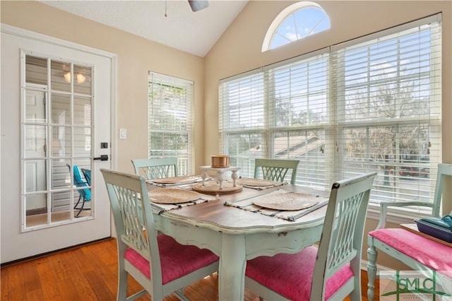 dining area featuring ceiling fan, vaulted ceiling, and wood finished floors