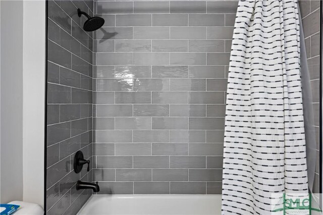 bathroom with shower / bath combo with shower curtain