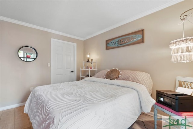 bedroom with wood-type flooring, ornamental molding, and a chandelier