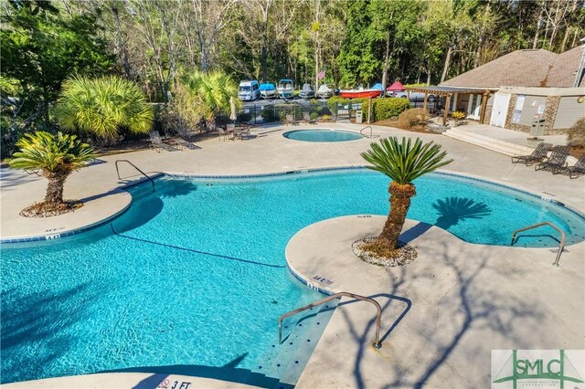 view of pool featuring a hot tub