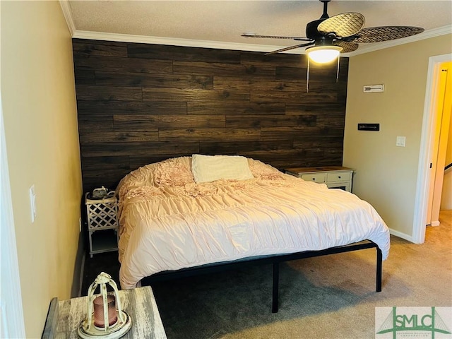 bedroom featuring ceiling fan, ornamental molding, wooden walls, and carpet