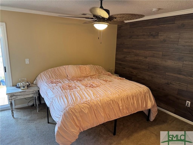 bedroom featuring carpet floors, ornamental molding, a ceiling fan, wooden walls, and a textured ceiling