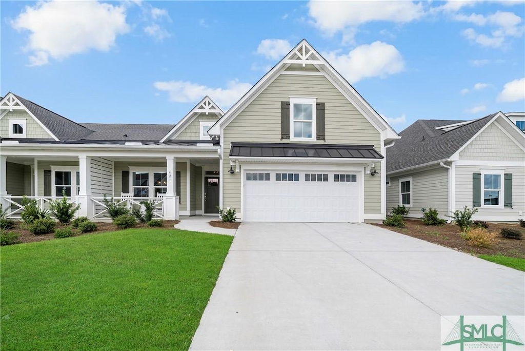 view of front of house with a garage, a porch, and a front lawn