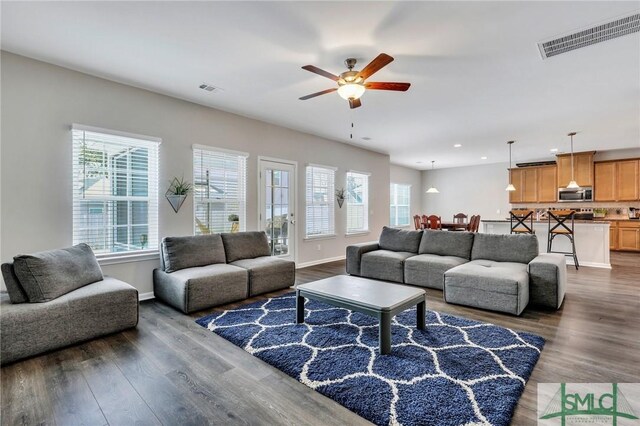 living room featuring dark hardwood / wood-style floors and ceiling fan