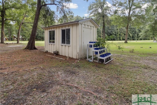 view of outbuilding featuring a lawn