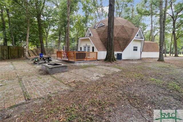 view of yard featuring a wooden deck and central AC unit