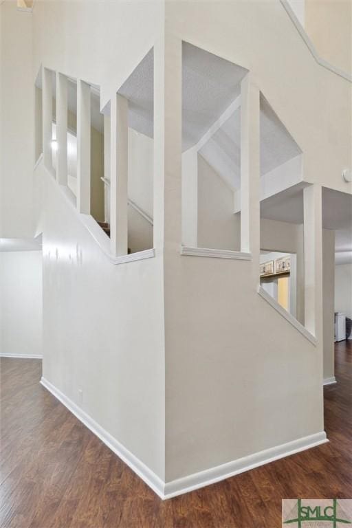 corridor featuring dark hardwood / wood-style flooring