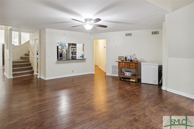 unfurnished living room featuring ceiling fan and dark hardwood / wood-style floors