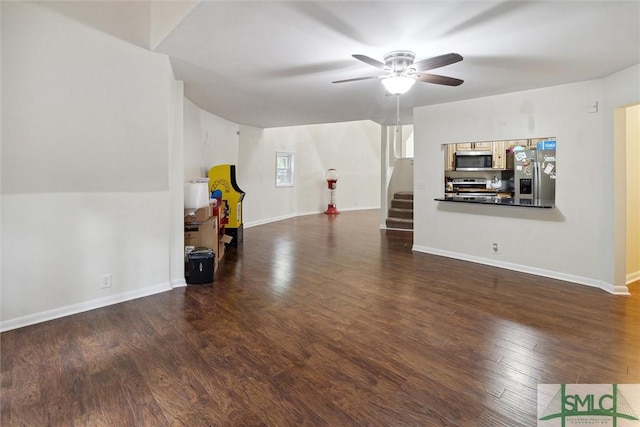 unfurnished living room featuring ceiling fan and dark hardwood / wood-style flooring