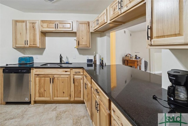 kitchen featuring dark stone countertops, sink, stainless steel dishwasher, and light brown cabinets