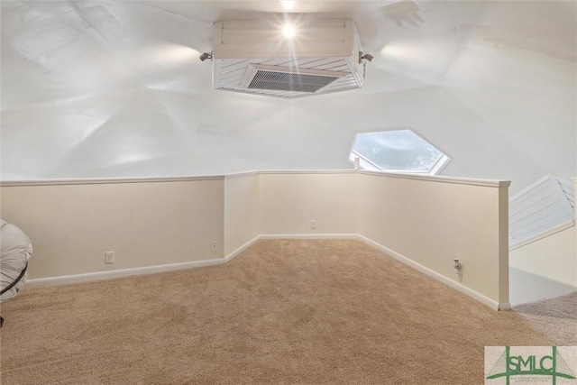 interior space with a skylight and carpet floors