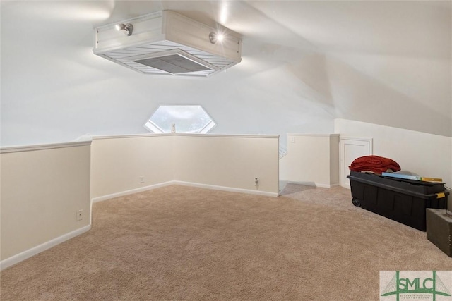 additional living space featuring lofted ceiling and light carpet