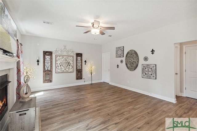 unfurnished living room featuring wood-type flooring and ceiling fan