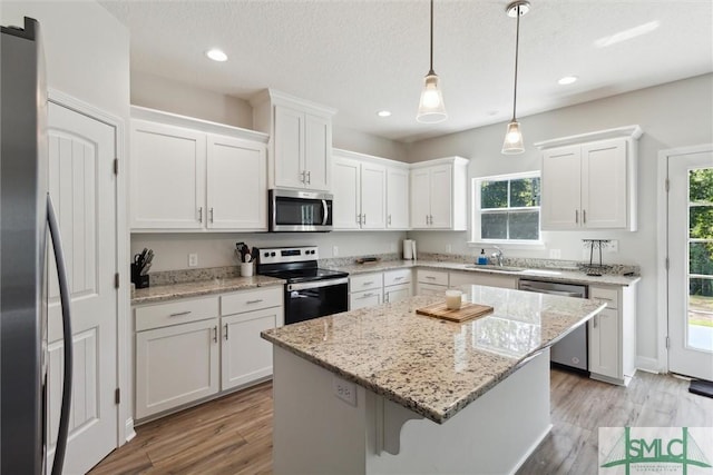 kitchen featuring a center island, white cabinets, and appliances with stainless steel finishes