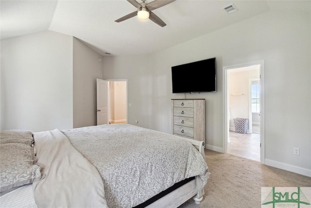 carpeted bedroom with lofted ceiling, ensuite bath, and ceiling fan