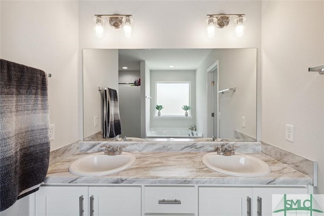 bathroom featuring vanity and a tub