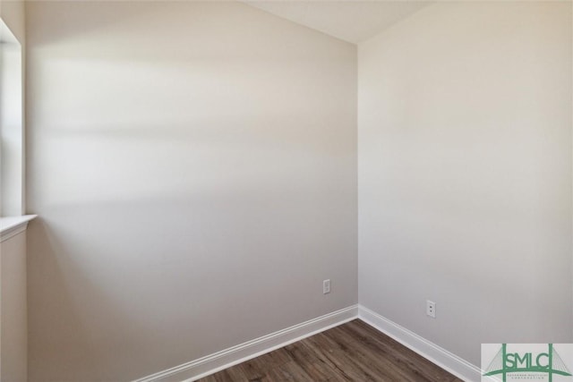 unfurnished room with dark hardwood / wood-style flooring