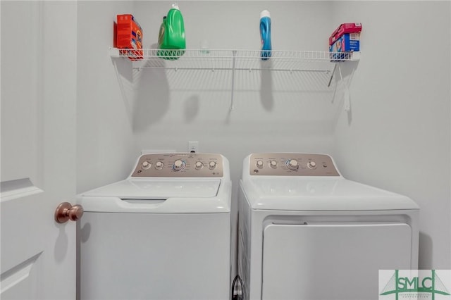 clothes washing area featuring independent washer and dryer