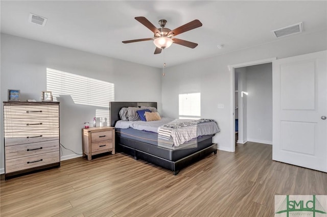 bedroom with wood-type flooring and ceiling fan