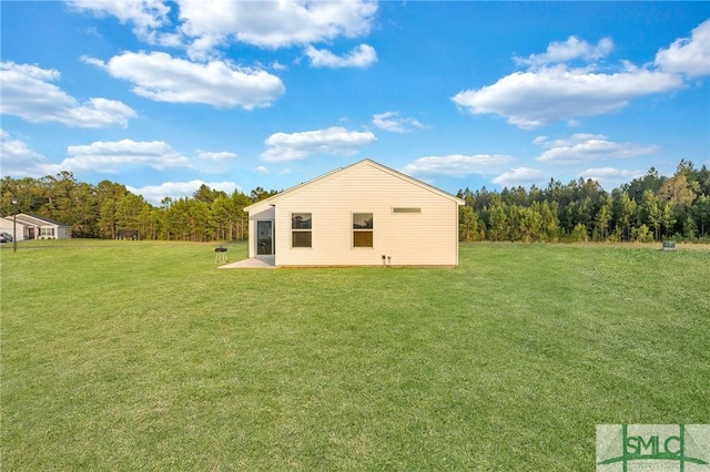 rear view of property with a lawn