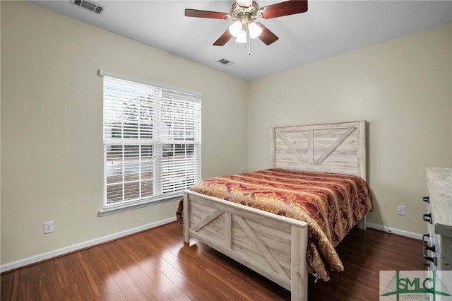 bedroom with dark hardwood / wood-style floors and ceiling fan